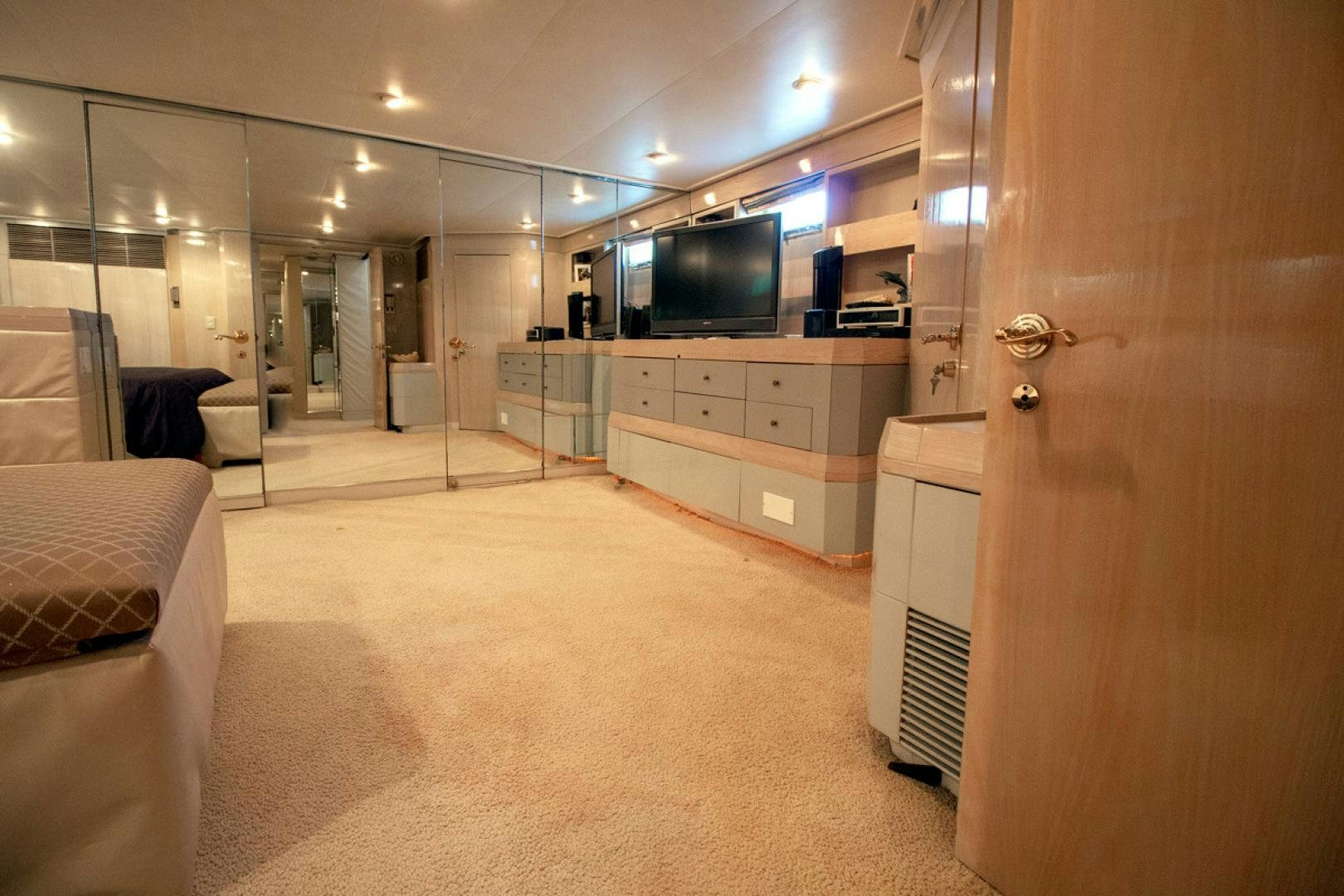 a room with a tv and a bed aboard LIQUIDITY Yacht for Sale