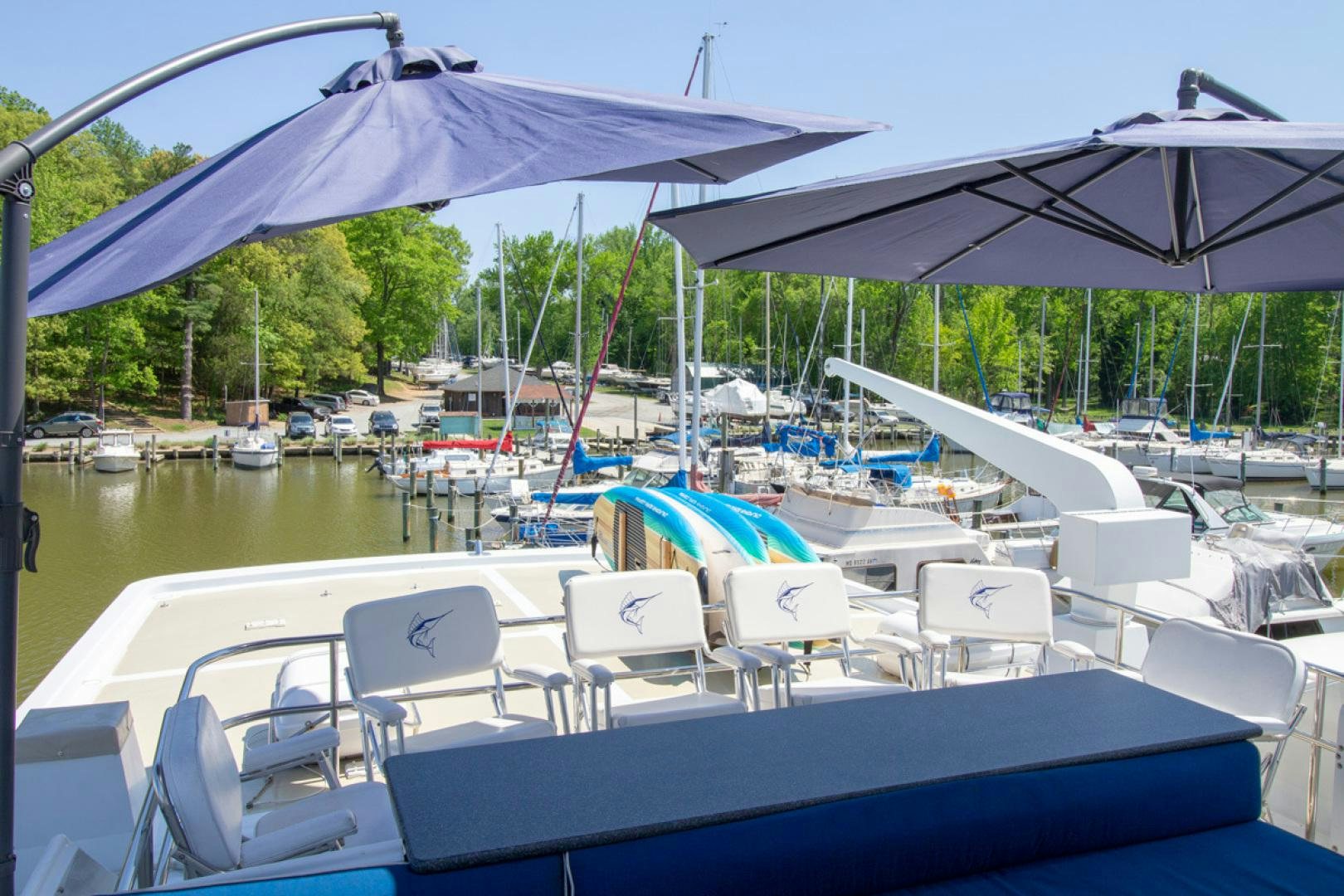a pool with lounge chairs and umbrellas aboard LIQUIDITY Yacht for Sale