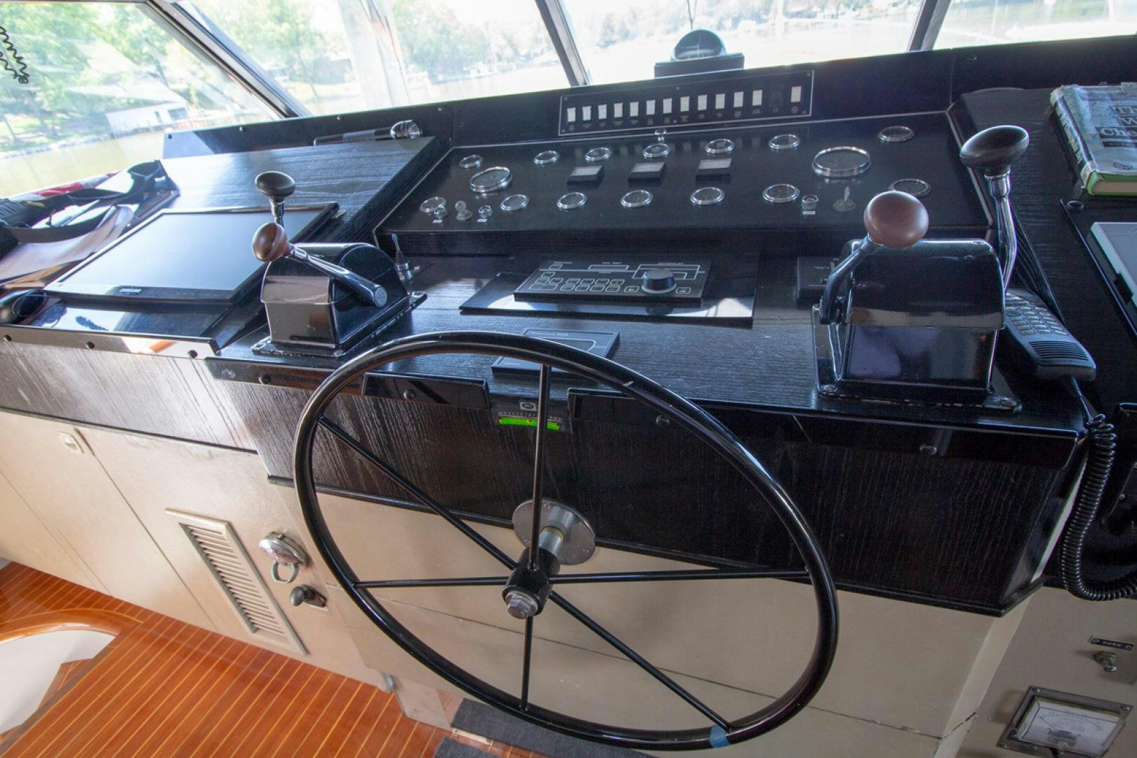 a black electronic device on a wooden surface aboard LIQUIDITY Yacht for Sale