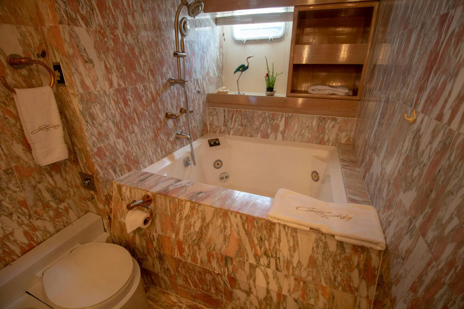 a bathroom with a tub sink and toilet aboard LIQUIDITY Yacht for Sale