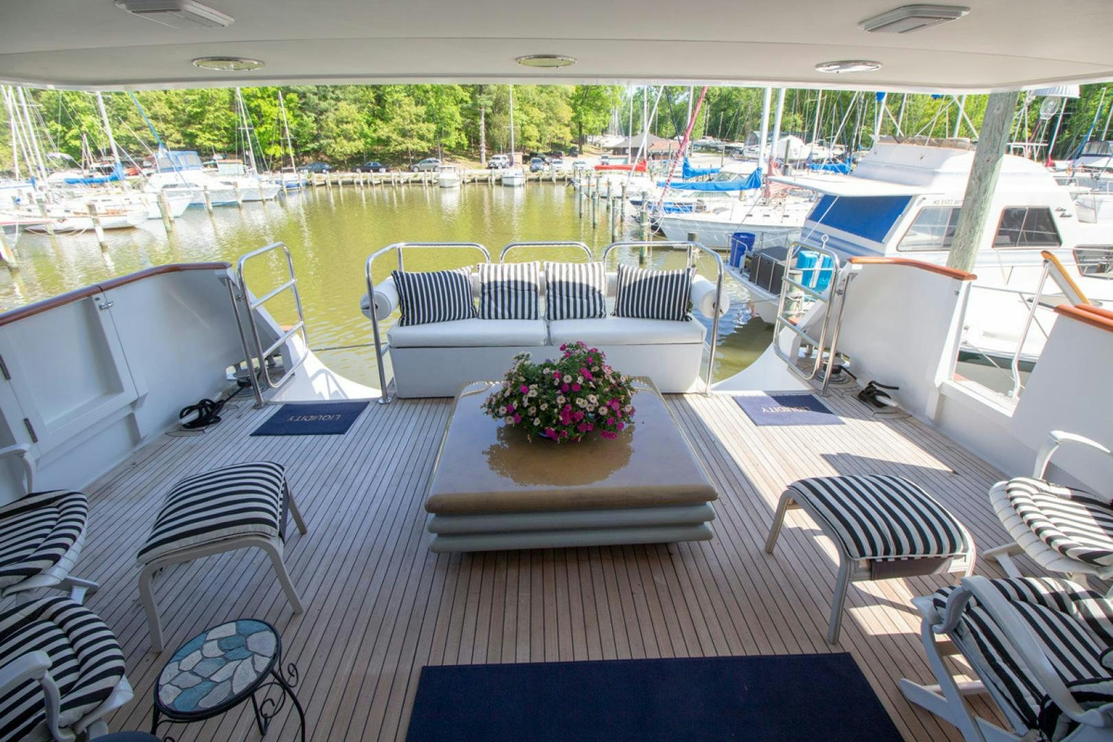 a boat with a flower pot on the deck aboard LIQUIDITY Yacht for Sale
