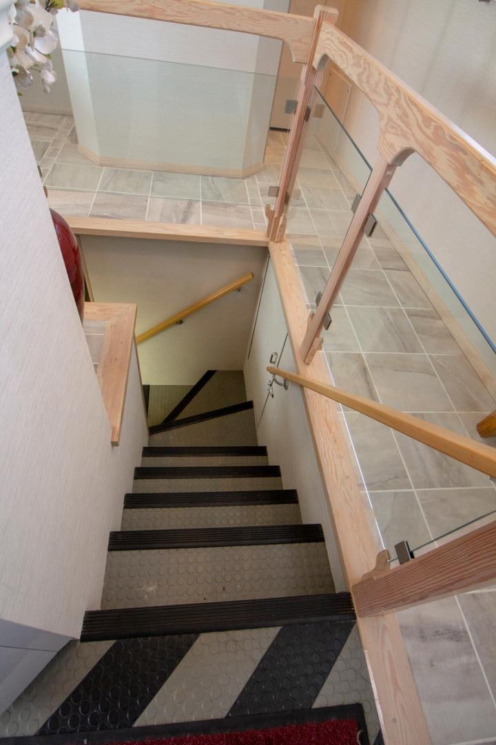 a set of stairs with a white wall and a black and white tile floor aboard LIQUIDITY Yacht for Sale