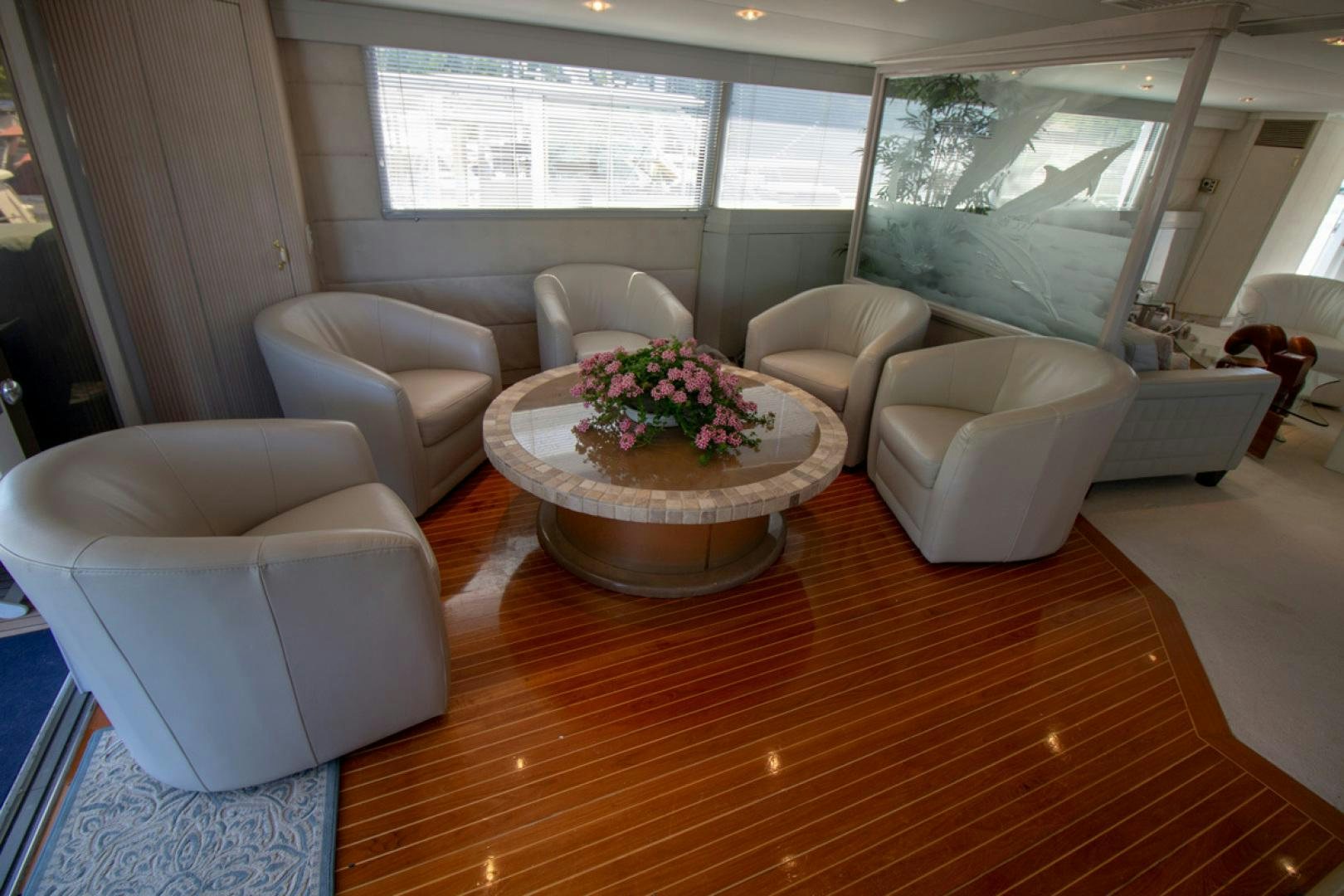 a living room with a table and chairs aboard LIQUIDITY Yacht for Sale