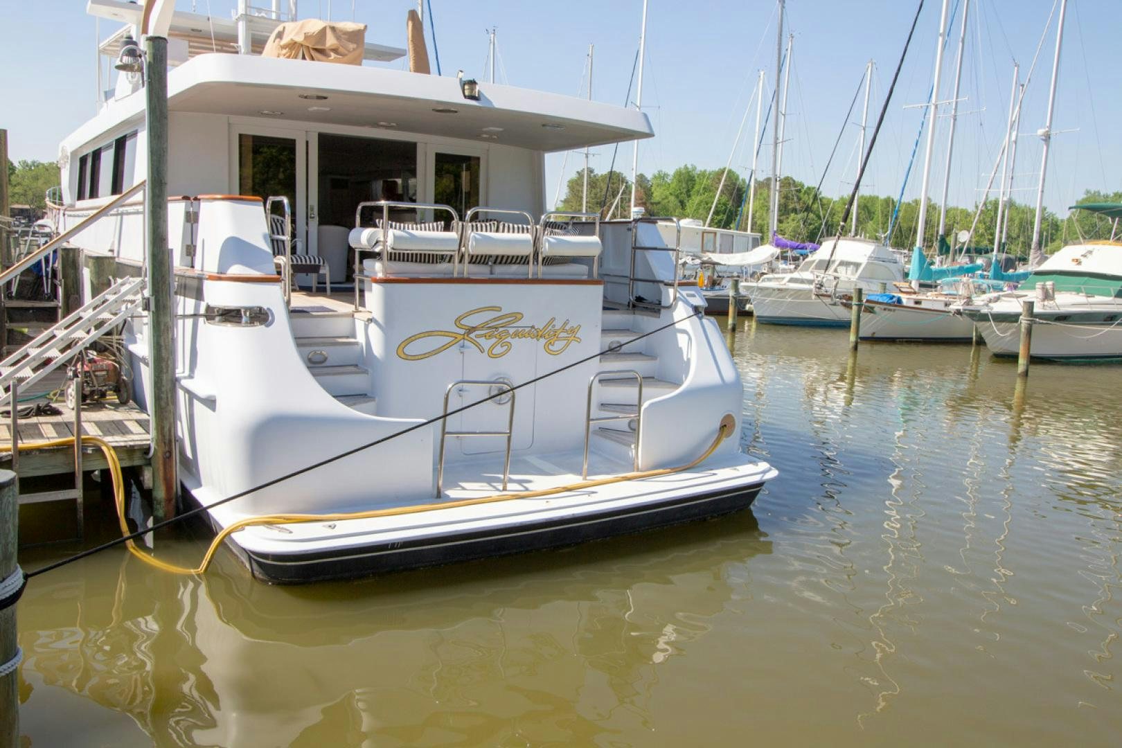 a boat docked at a pier aboard LIQUIDITY Yacht for Sale