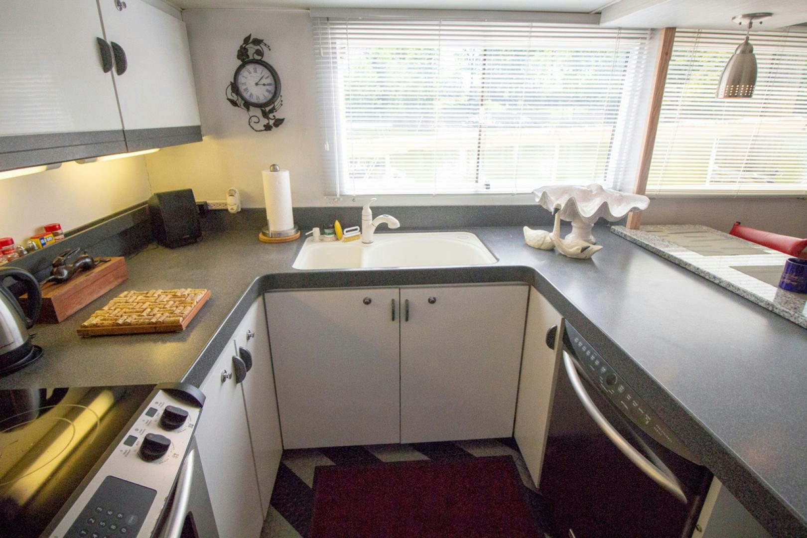 a kitchen with a stove and sink aboard LIQUIDITY Yacht for Sale