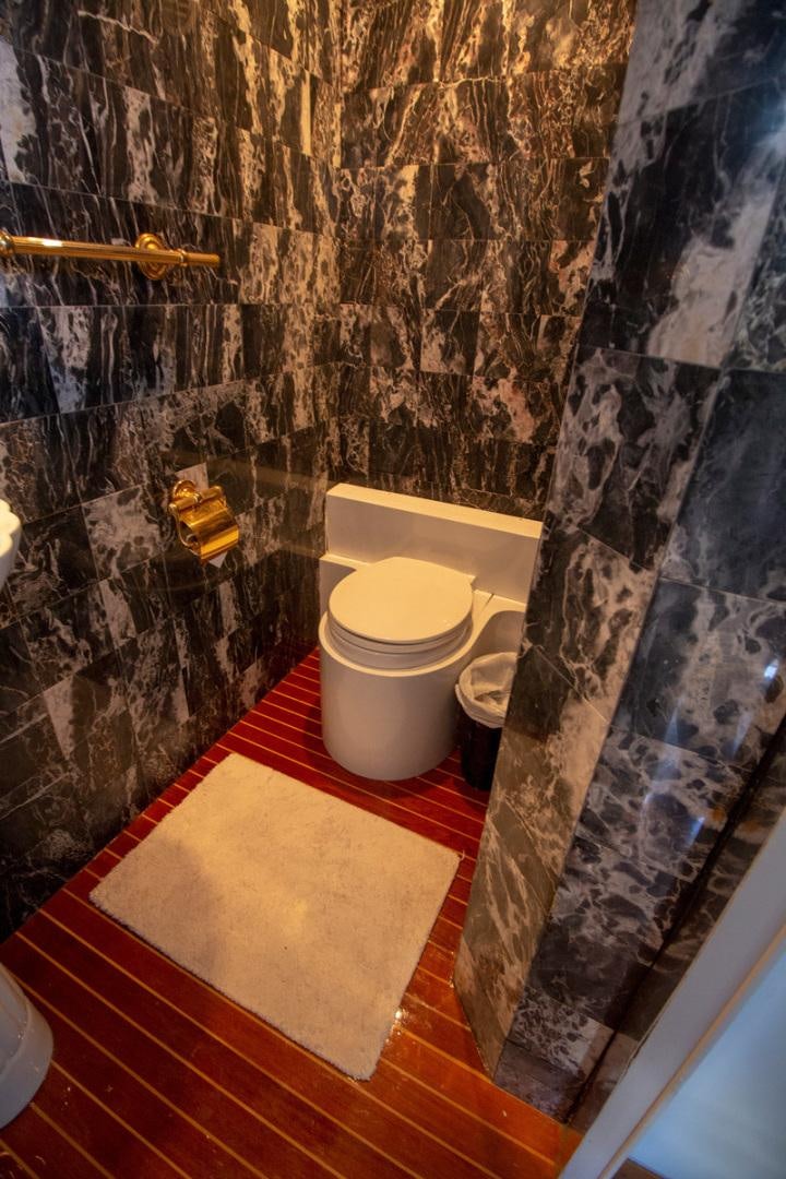 a bathroom with a toilet and a shower aboard LIQUIDITY Yacht for Sale