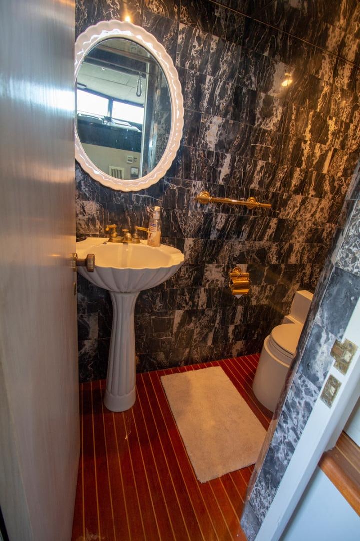 a bathroom with a sink and a mirror aboard LIQUIDITY Yacht for Sale