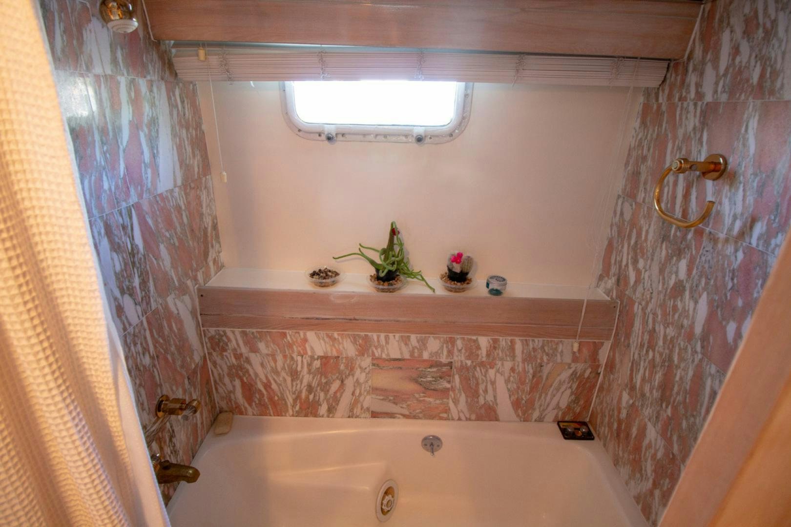 a bathroom with a bathtub and a sink aboard LIQUIDITY Yacht for Sale
