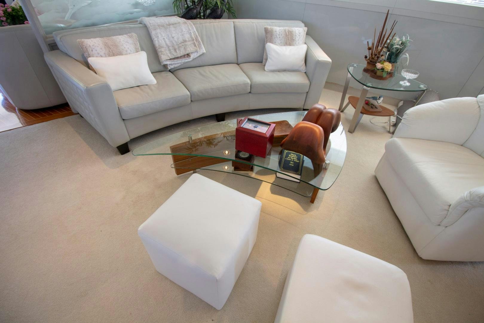 a living room with a couch and coffee table aboard LIQUIDITY Yacht for Sale
