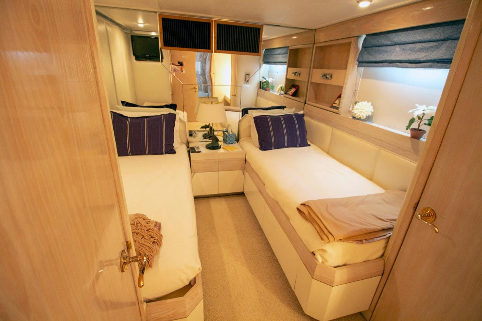 a room with a bed and a mirror aboard LIQUIDITY Yacht for Sale