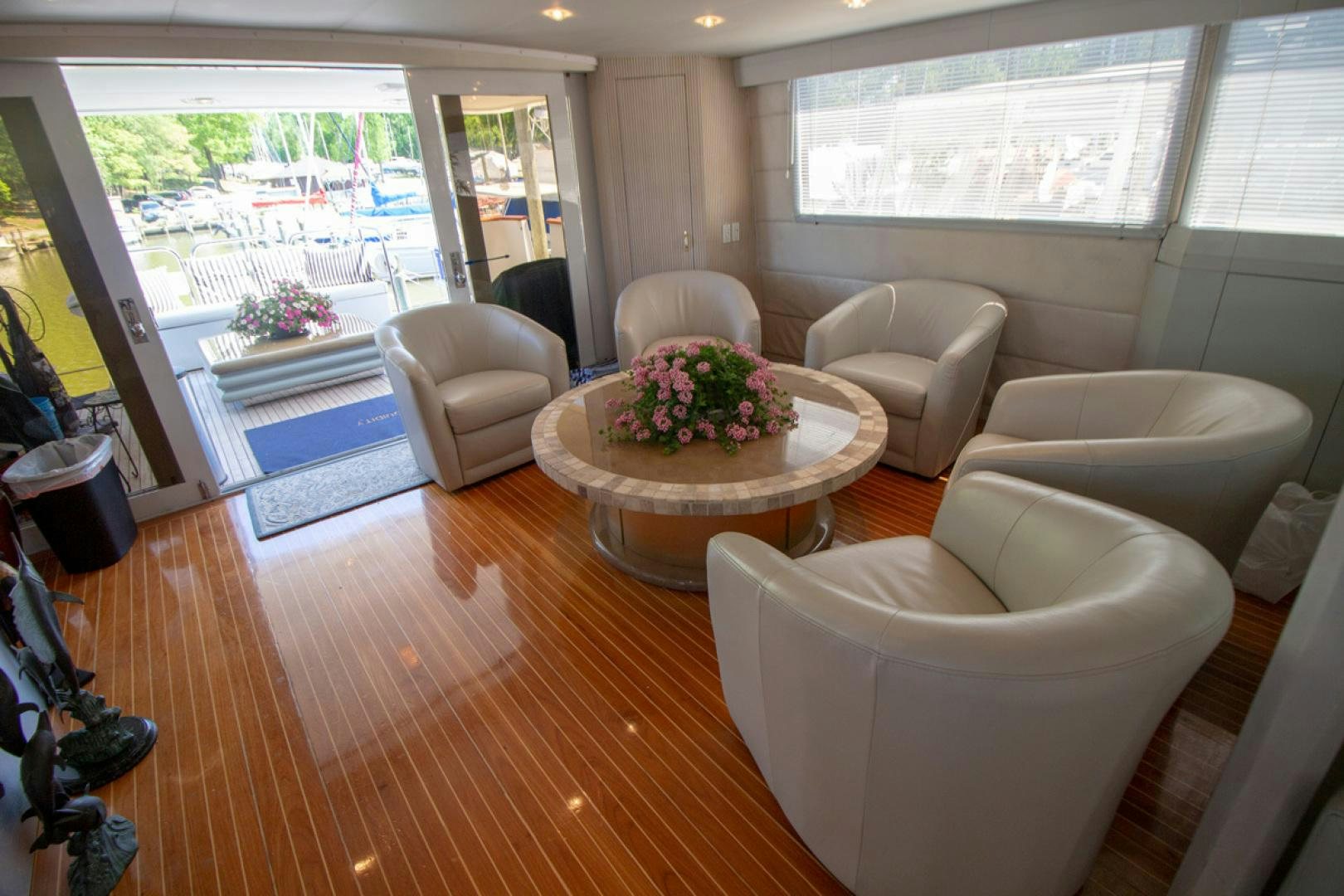 a living room with a table and chairs aboard LIQUIDITY Yacht for Sale