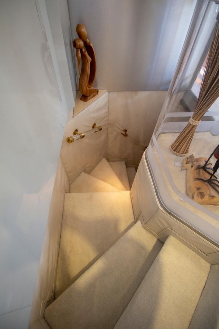 a cat sitting on a staircase aboard LIQUIDITY Yacht for Sale