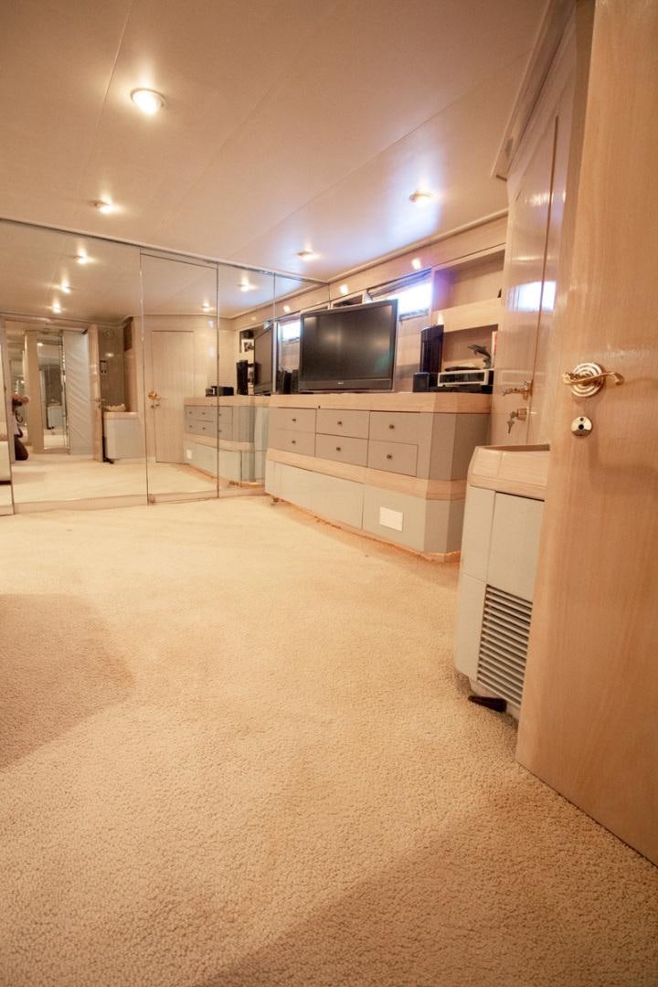 a room with a tv and a cabinet aboard LIQUIDITY Yacht for Sale