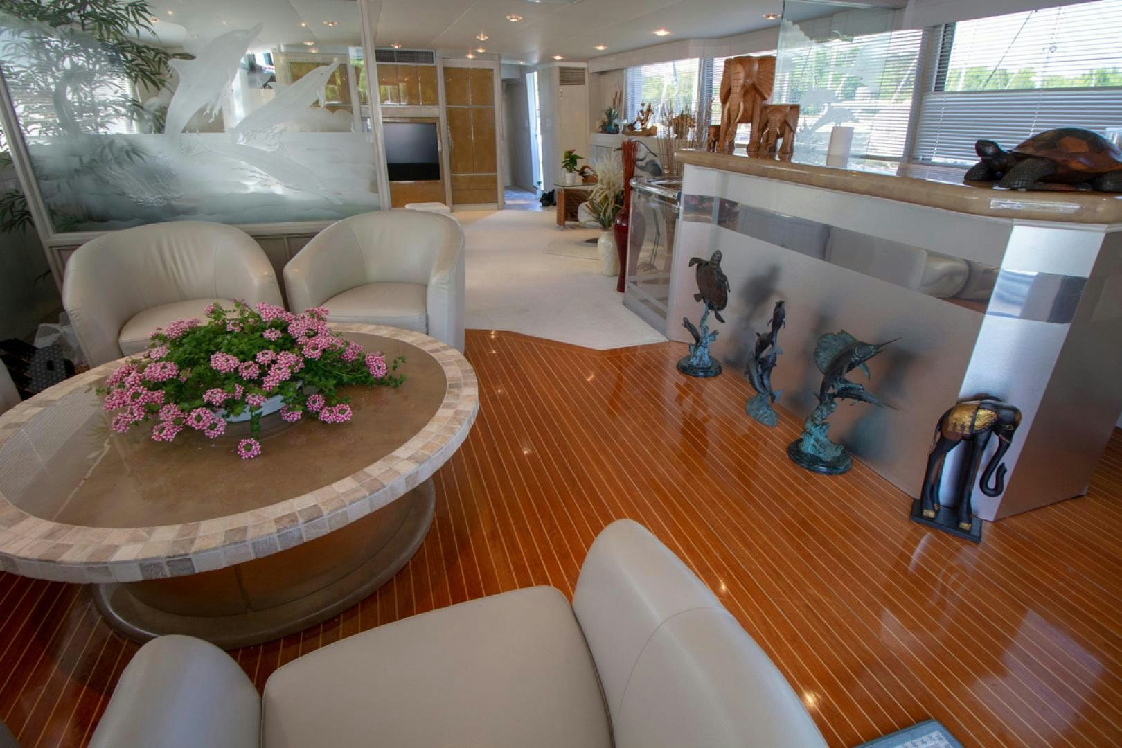 a living room with a large mirror aboard LIQUIDITY Yacht for Sale