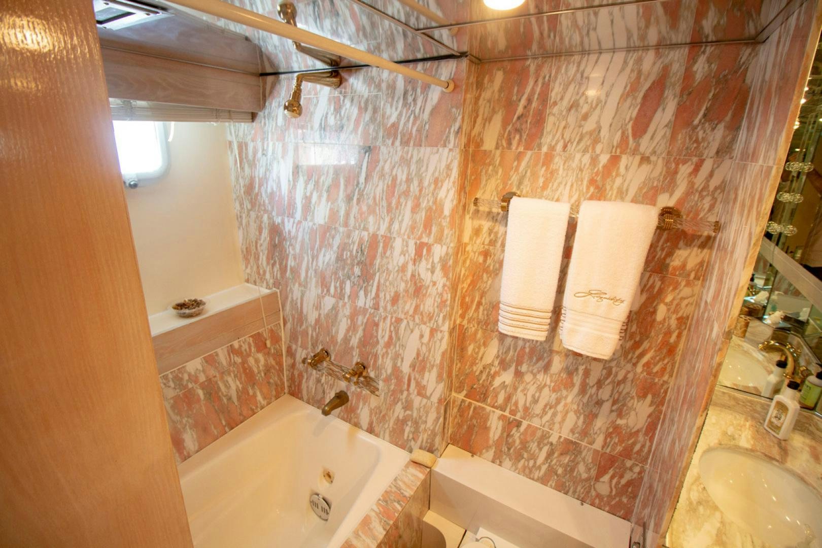 a bathroom with a bathtub and toilet aboard LIQUIDITY Yacht for Sale