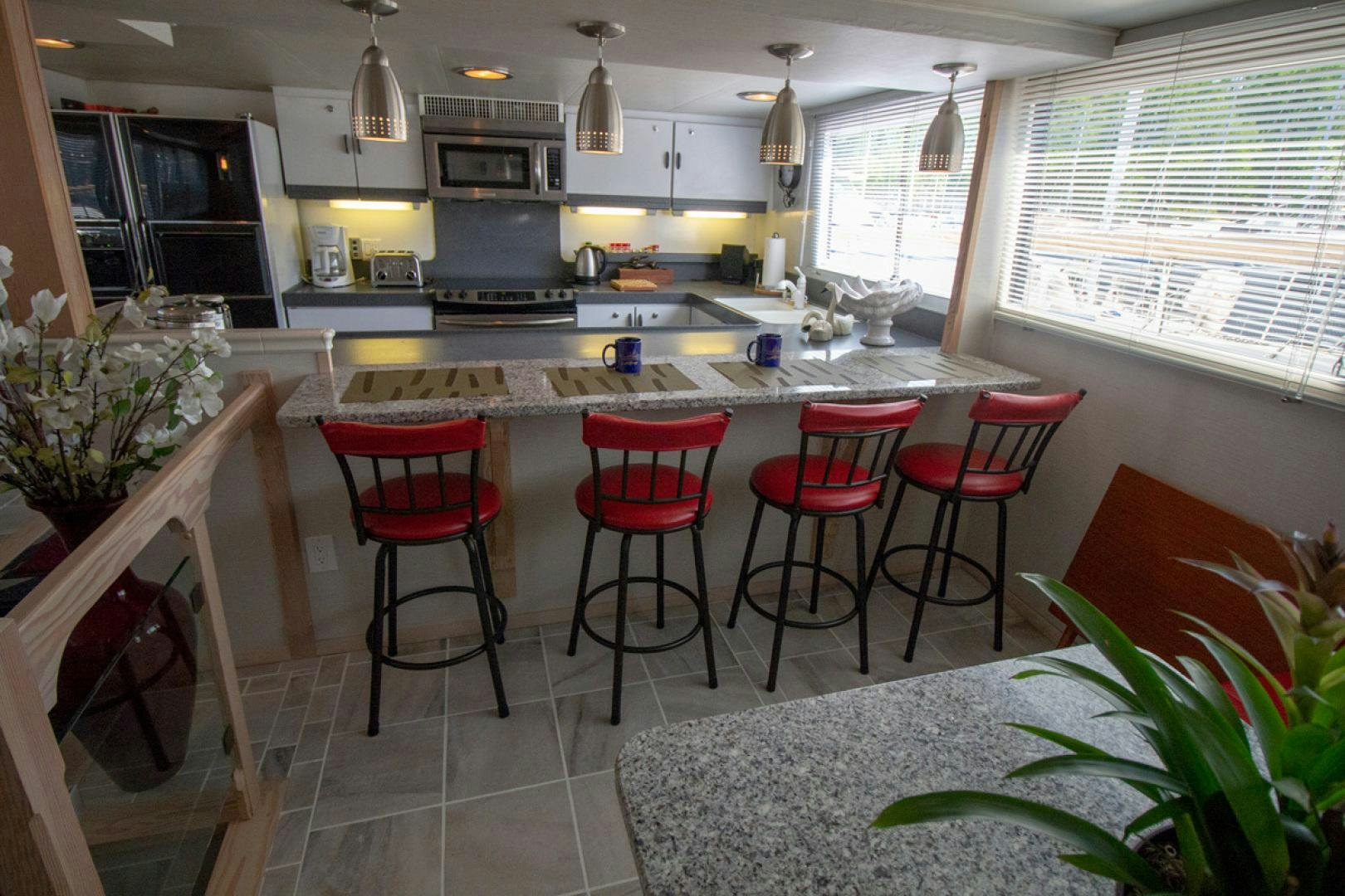 a kitchen with a table and chairs aboard LIQUIDITY Yacht for Sale