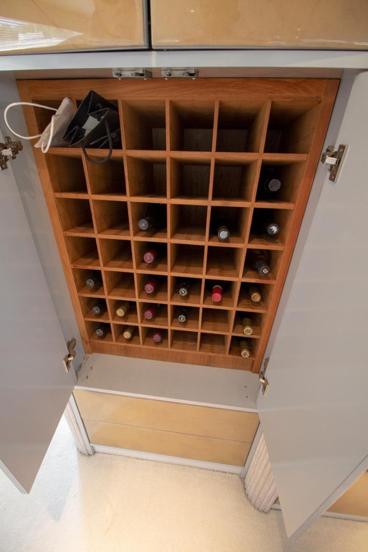 a cabinet with many bottles in it aboard LIQUIDITY Yacht for Sale