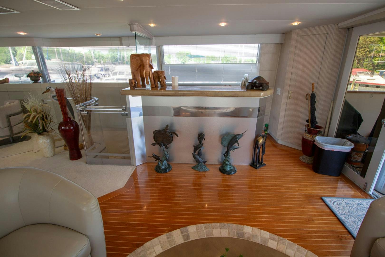 a room with a fireplace and statues aboard LIQUIDITY Yacht for Sale