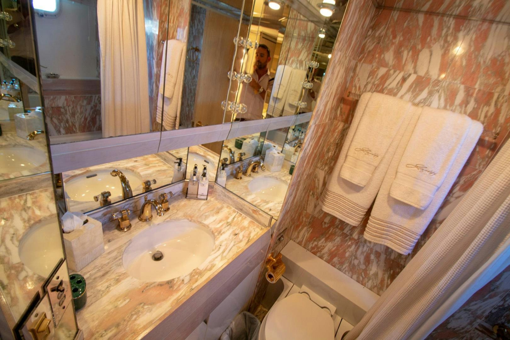 a bathroom with a sink and a mirror aboard LIQUIDITY Yacht for Sale