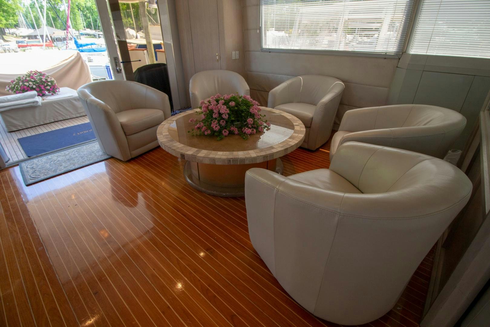 a living room with a table and chairs aboard LIQUIDITY Yacht for Sale