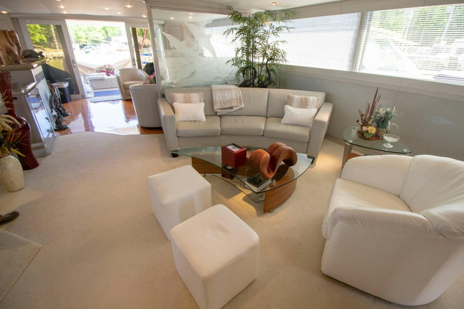 a living room with white furniture aboard LIQUIDITY Yacht for Sale
