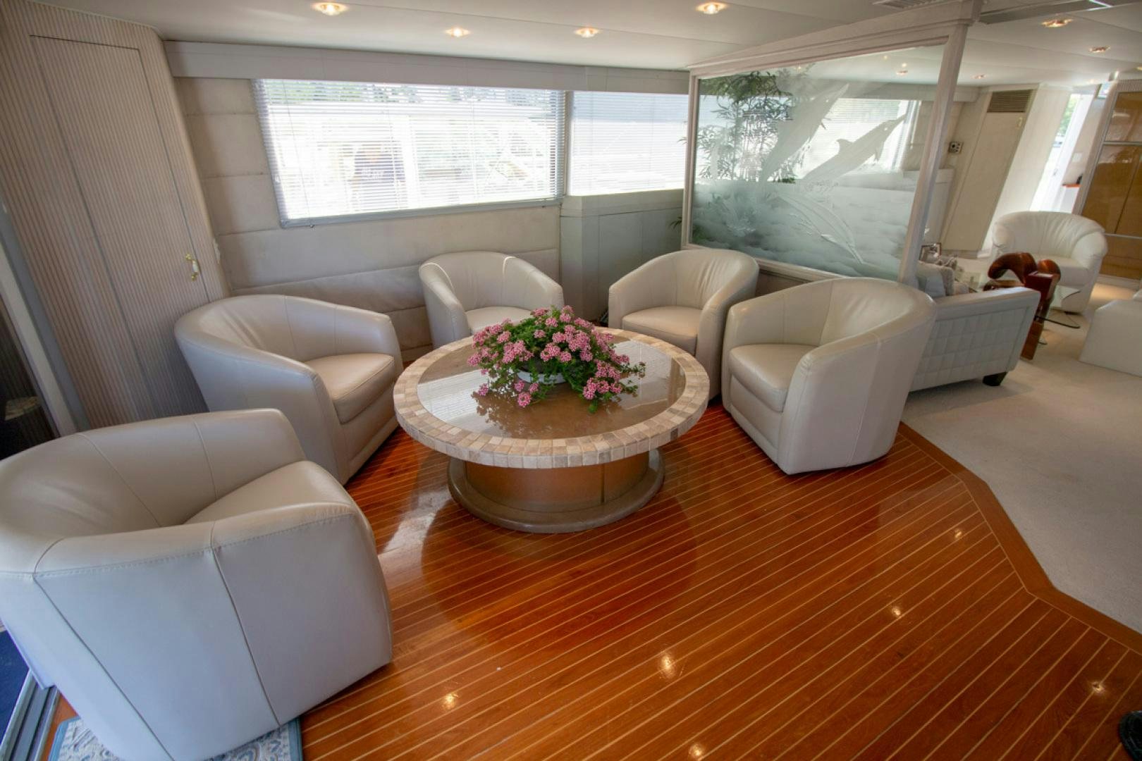 a living room with a table and chairs aboard LIQUIDITY Yacht for Sale
