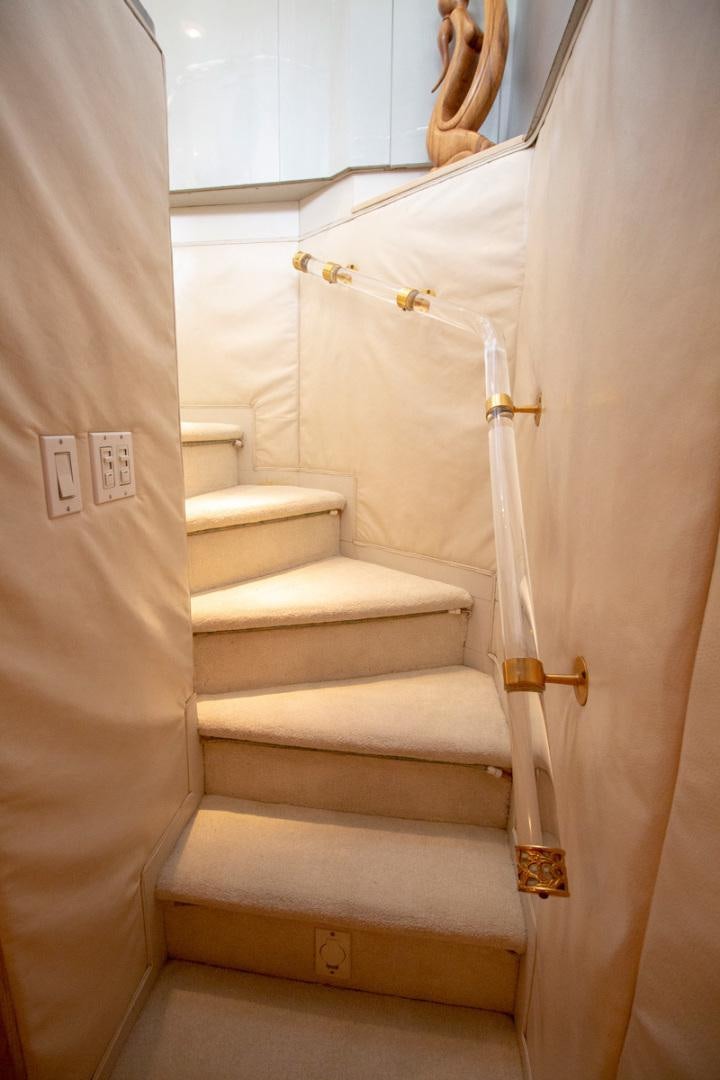a white staircase with a gold door aboard LIQUIDITY Yacht for Sale