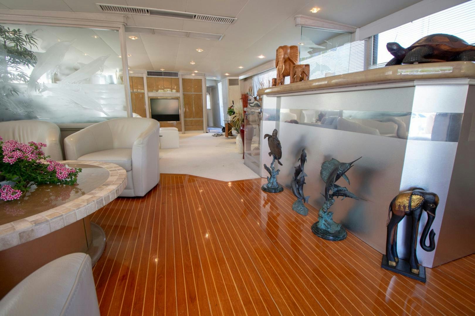 a room with a table and couches aboard LIQUIDITY Yacht for Sale