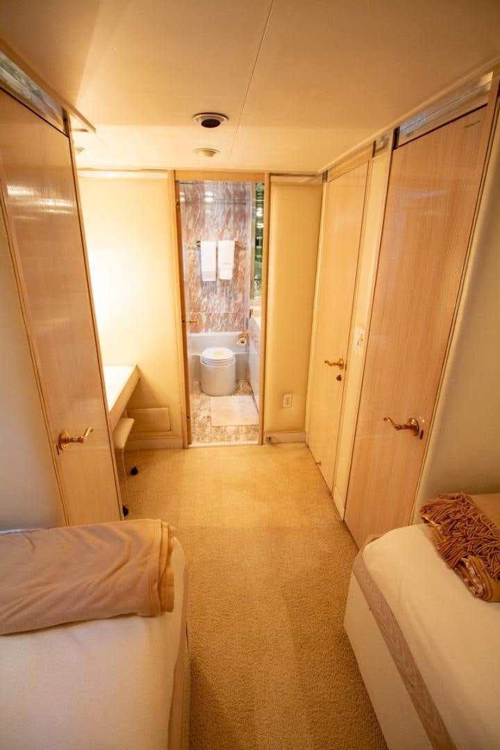 a room with a bed and a door aboard LIQUIDITY Yacht for Sale
