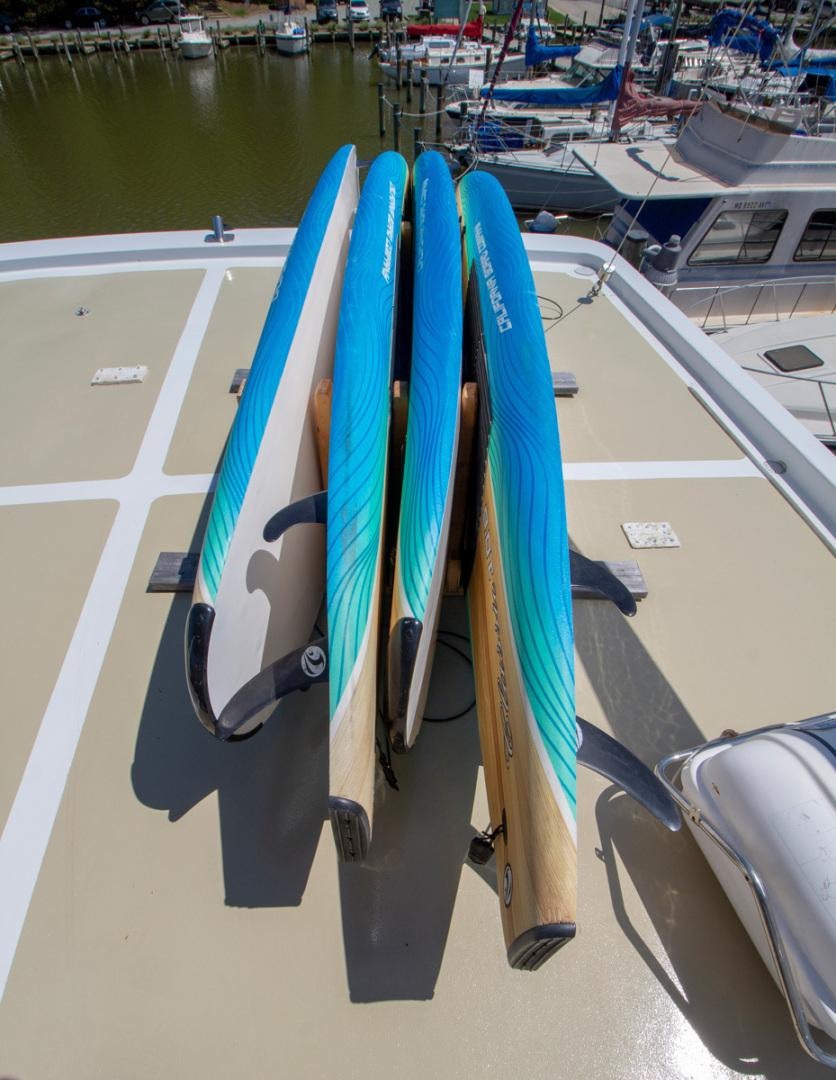 surfboards on a rack aboard LIQUIDITY Yacht for Sale