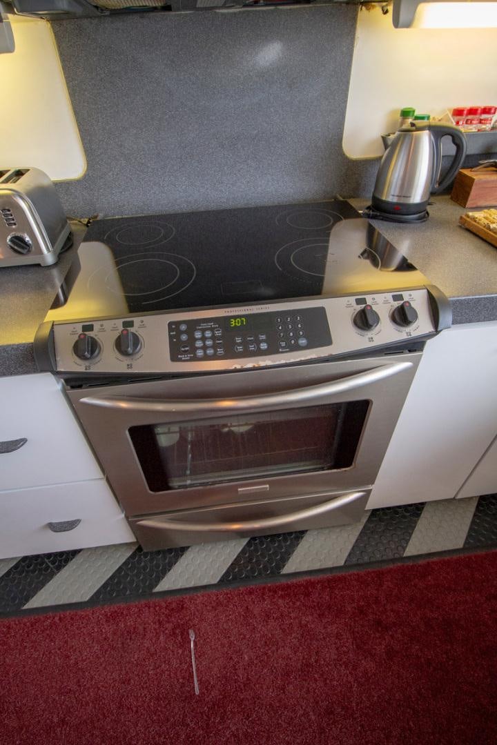 a white stove with a plaque on it aboard LIQUIDITY Yacht for Sale