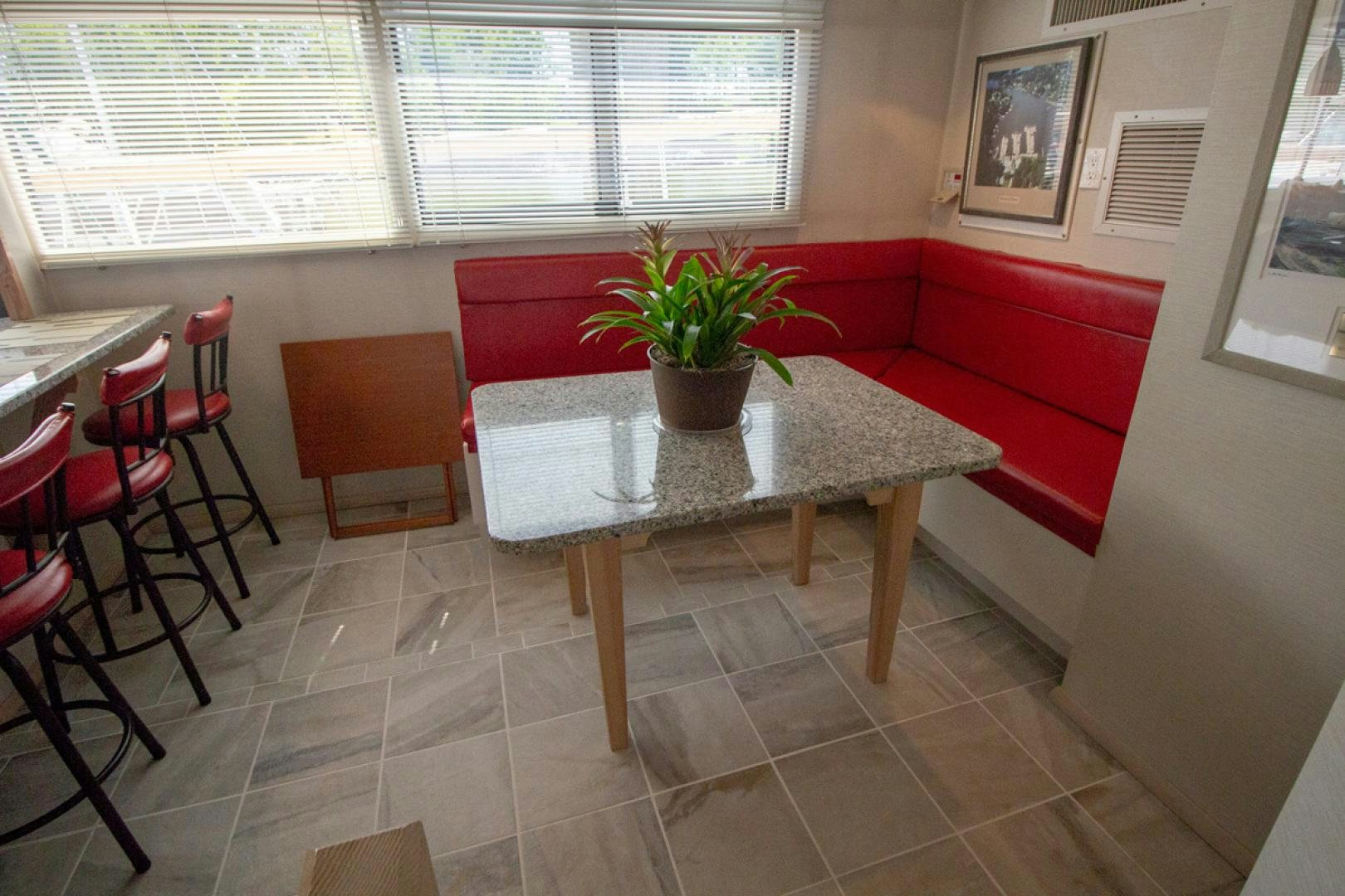 a table with a plant on it aboard LIQUIDITY Yacht for Sale