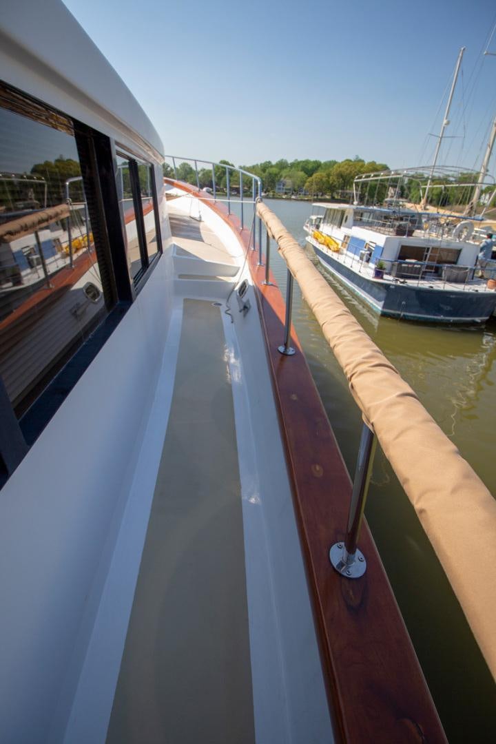 a boat is parked on the side of the water aboard LIQUIDITY Yacht for Sale
