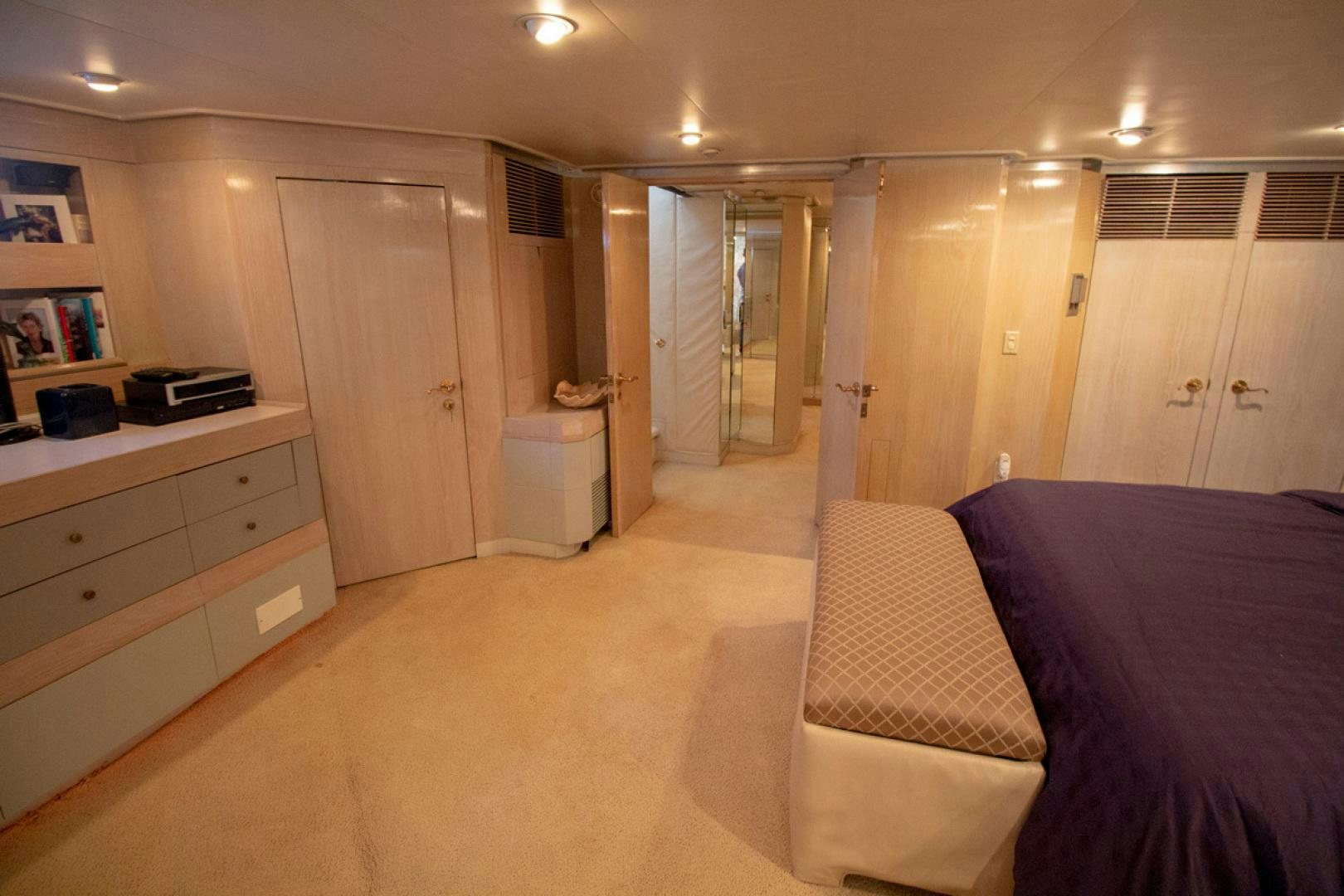a bedroom with a bed and a desk aboard LIQUIDITY Yacht for Sale