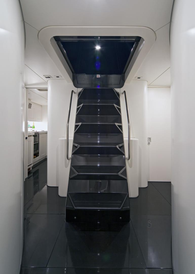 a black and white staircase aboard DARK SHADOW Yacht for Sale
