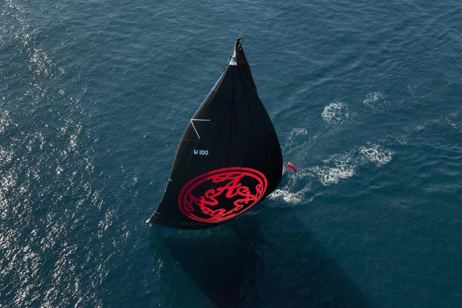 a black and red boat in the water aboard DARK SHADOW Yacht for Sale