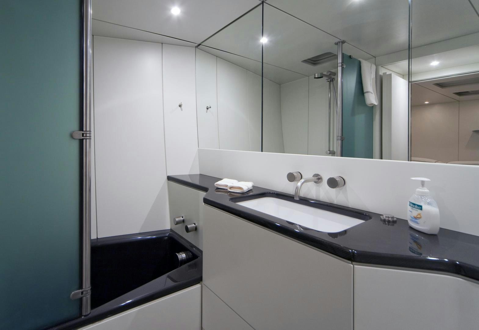 a bathroom with a large mirror aboard DARK SHADOW Yacht for Sale