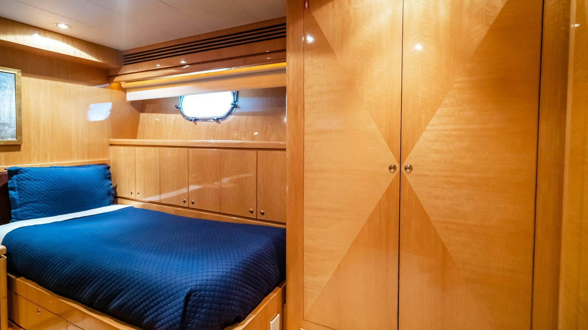 a room with a bed and a closet aboard VITESSE Yacht for Sale