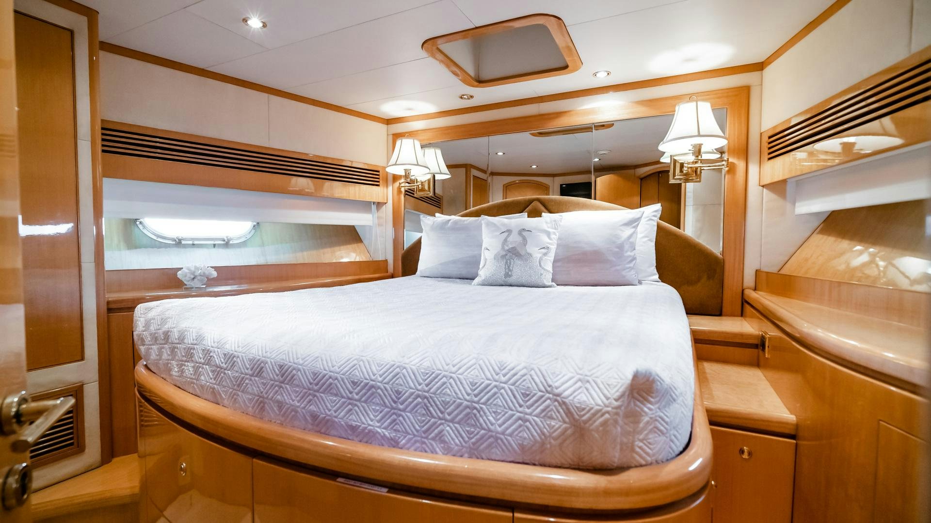 a bed with a white comforter aboard VITESSE Yacht for Sale