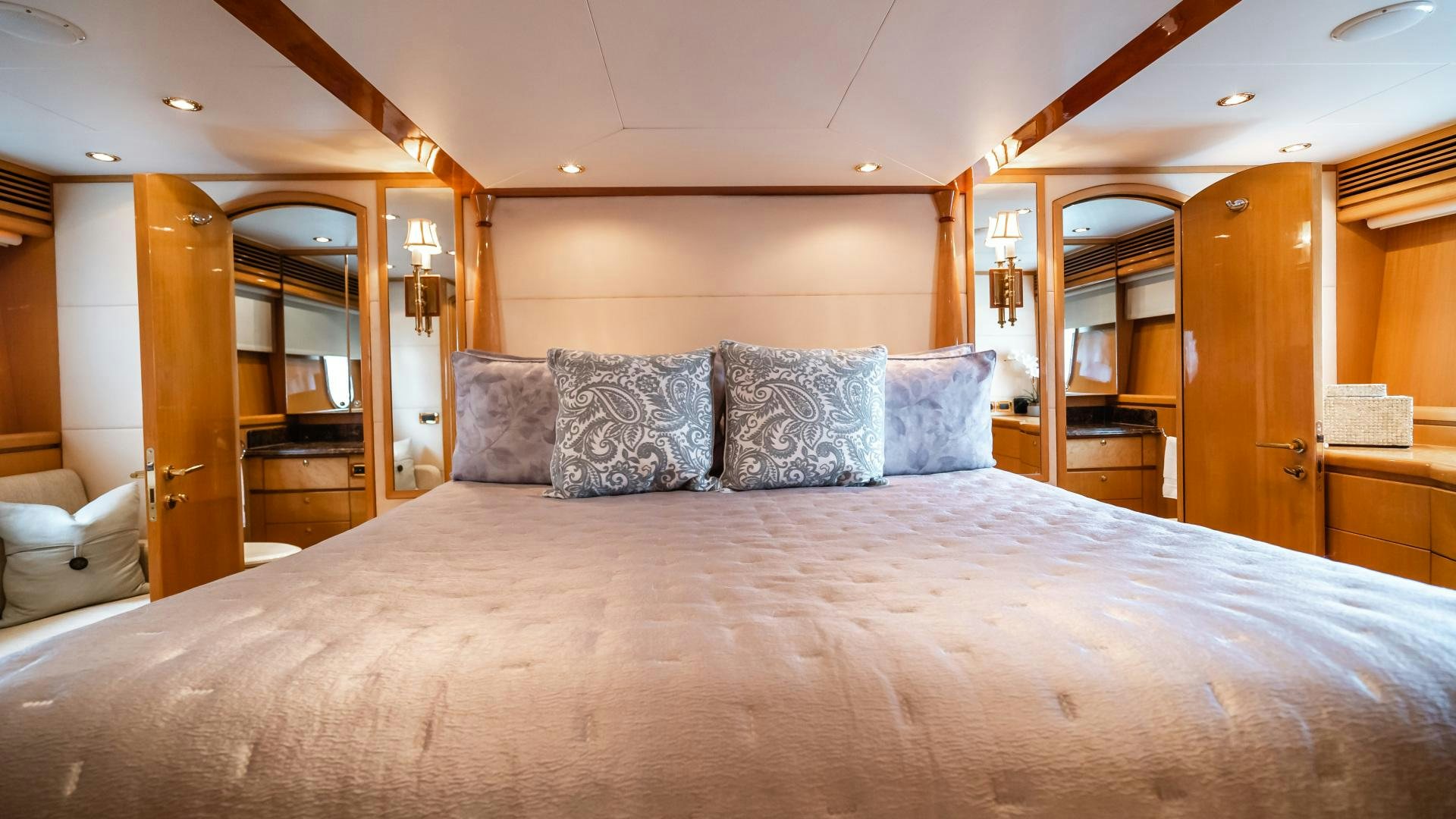 a bed with pillows on it aboard VITESSE Yacht for Sale