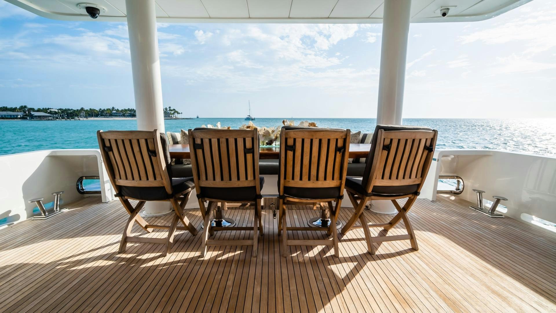 a group of chairs on a deck overlooking a body of water aboard VITESSE Yacht for Sale