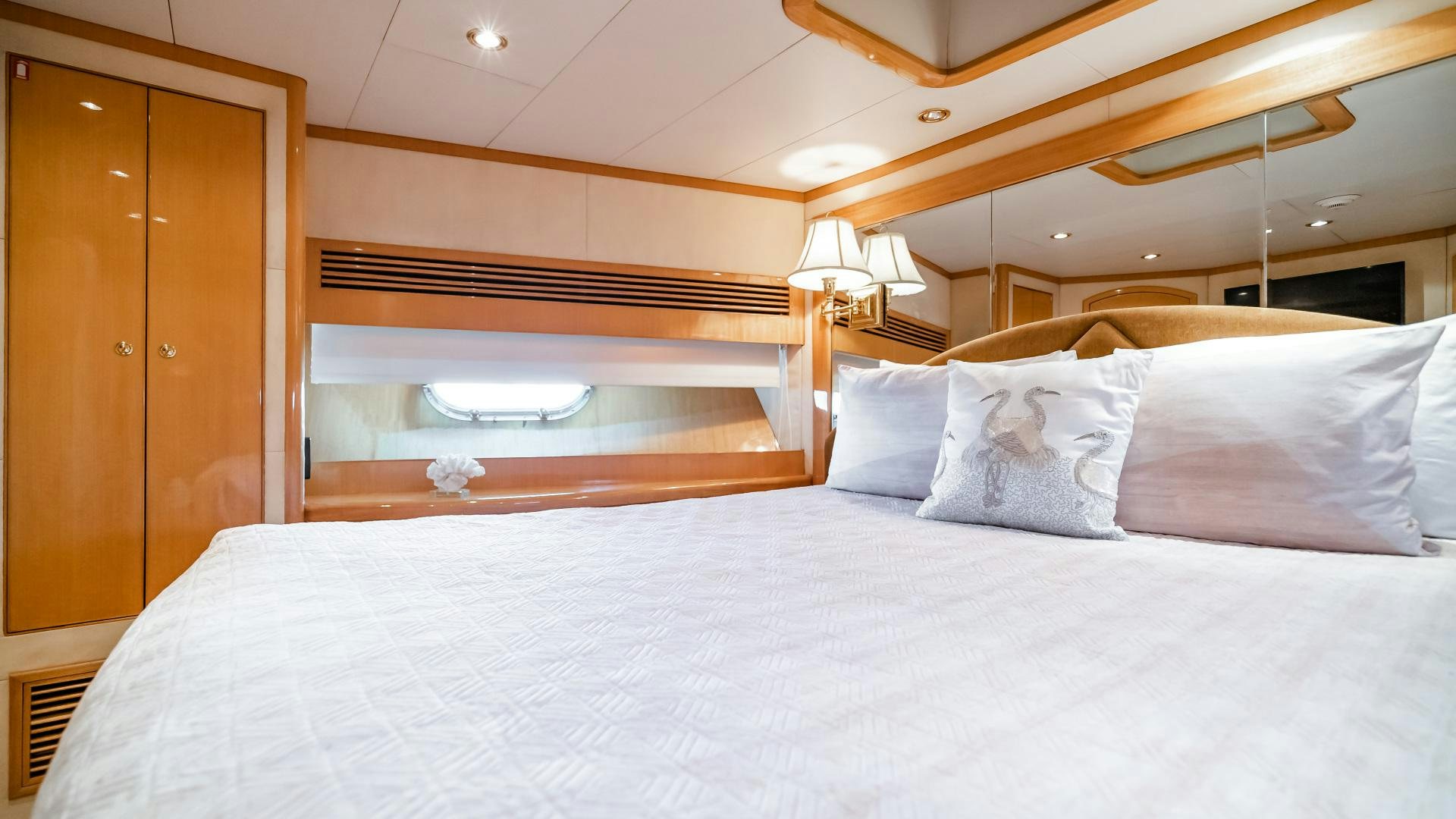 a bed with white sheets aboard VITESSE Yacht for Sale
