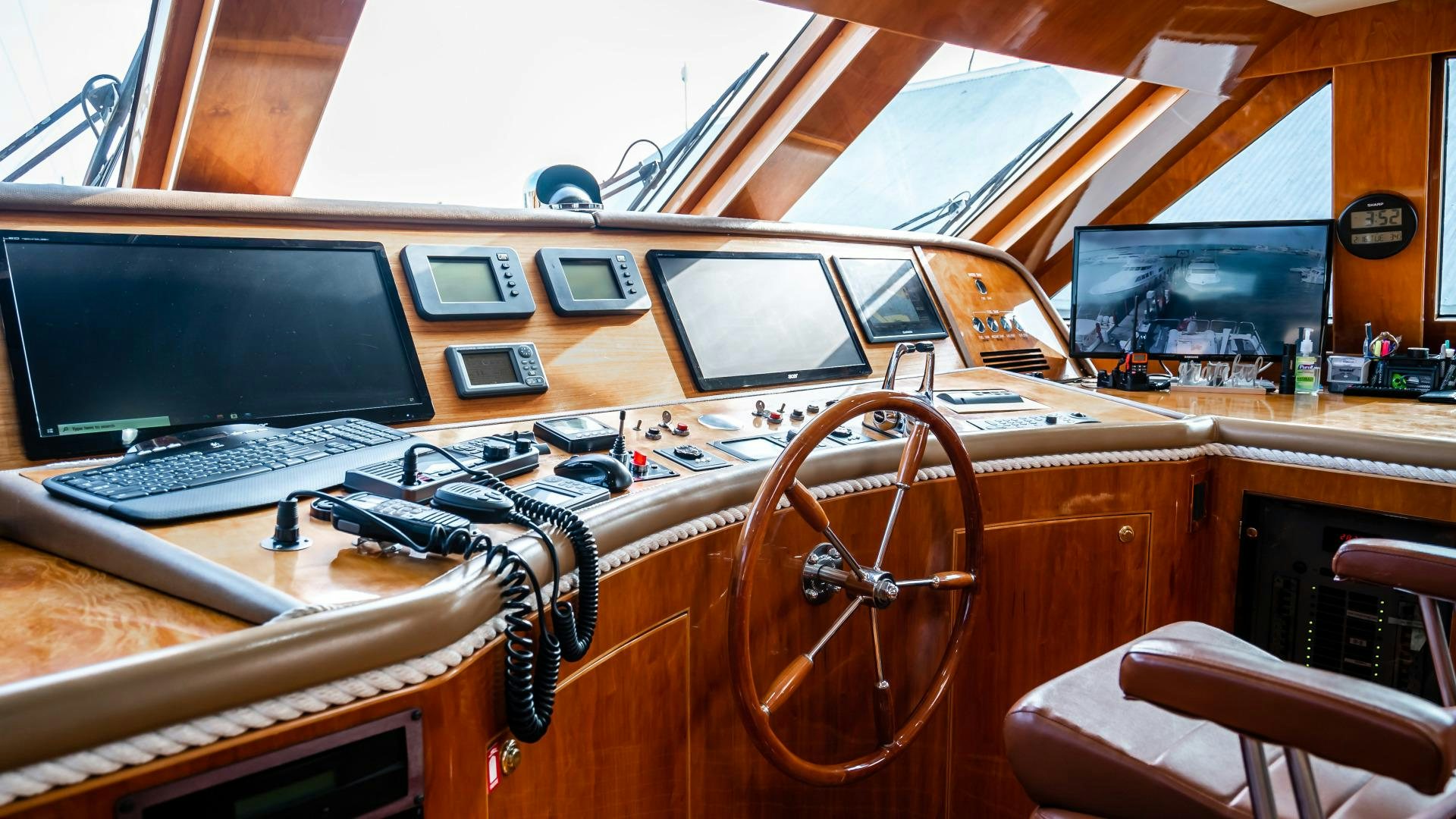 a wooden desk with a computer and other electronics on it aboard VITESSE Yacht for Sale