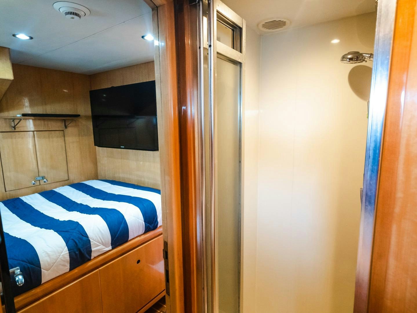 a room with a bed and a closet aboard VITESSE Yacht for Sale