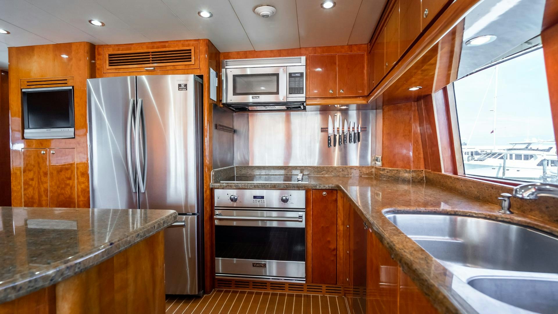 a kitchen with wooden cabinets aboard VITESSE Yacht for Sale