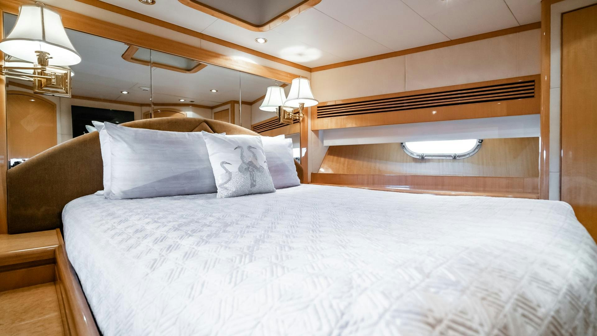 a bed with white sheets and pillows aboard VITESSE Yacht for Sale