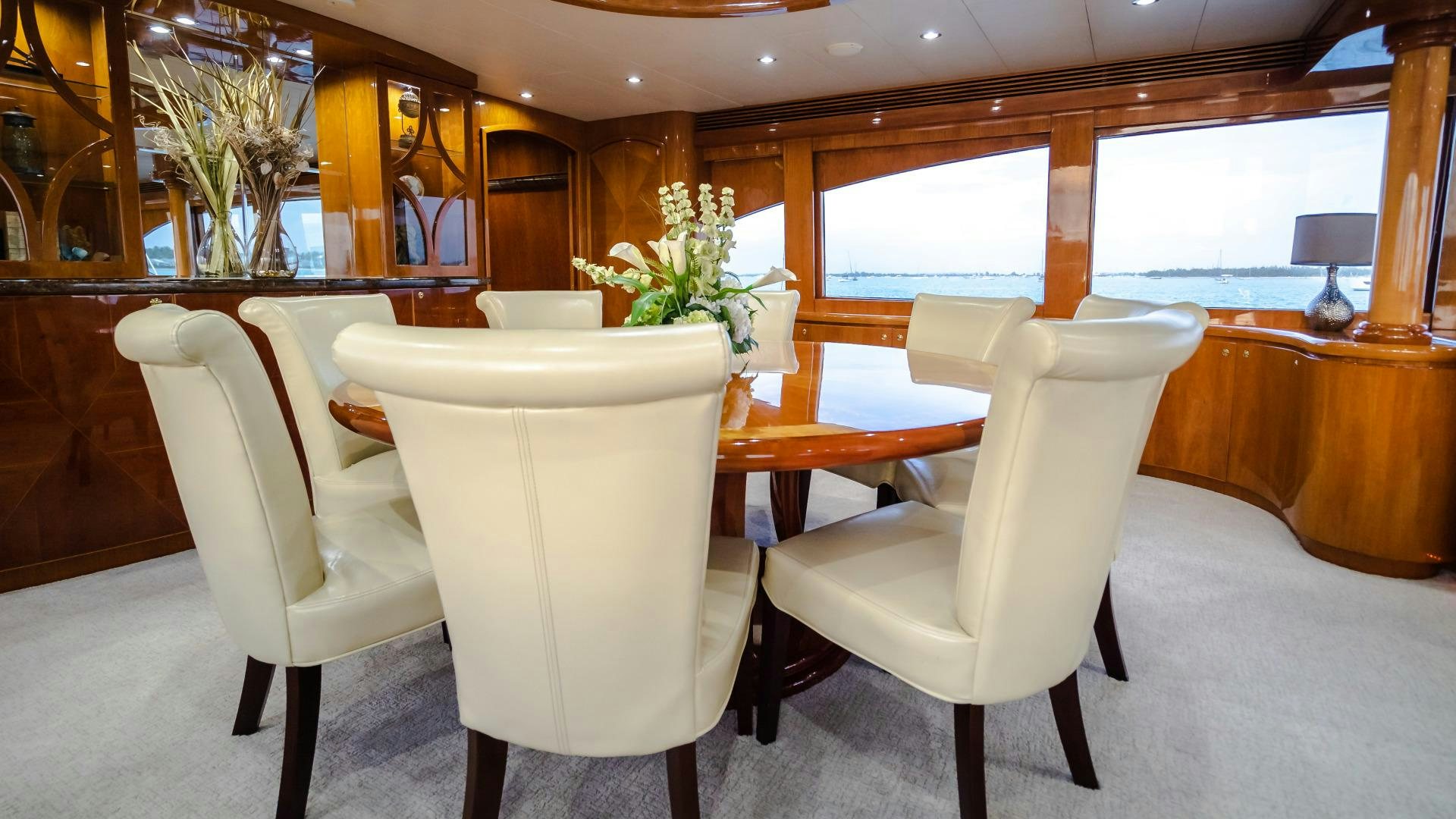 a room with tables and chairs aboard VITESSE Yacht for Sale