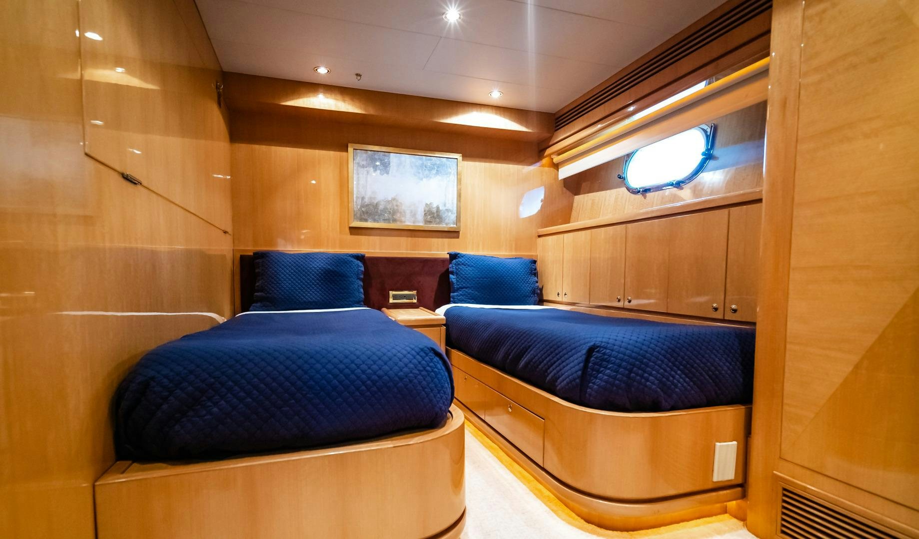 a room with a bed and a couch aboard VITESSE Yacht for Sale
