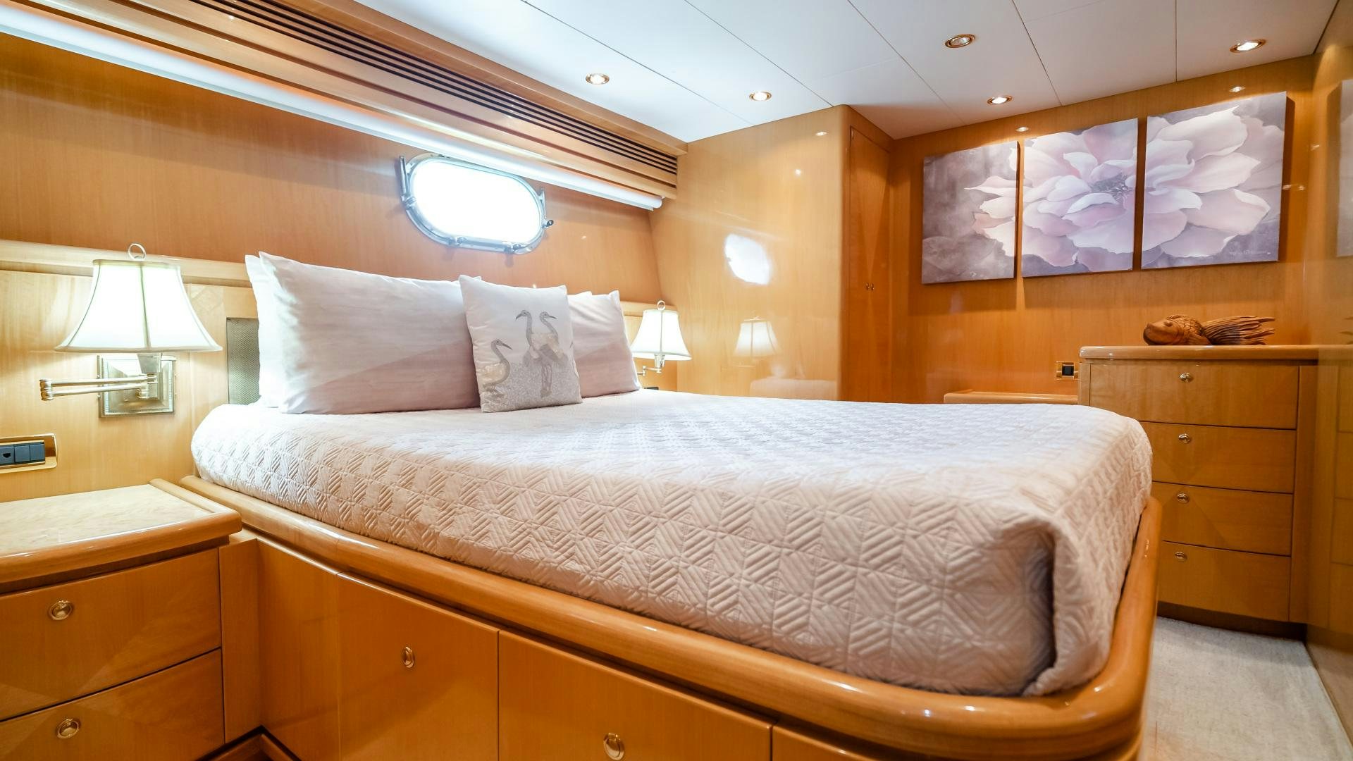 a bed with white sheets and pillows aboard VITESSE Yacht for Sale