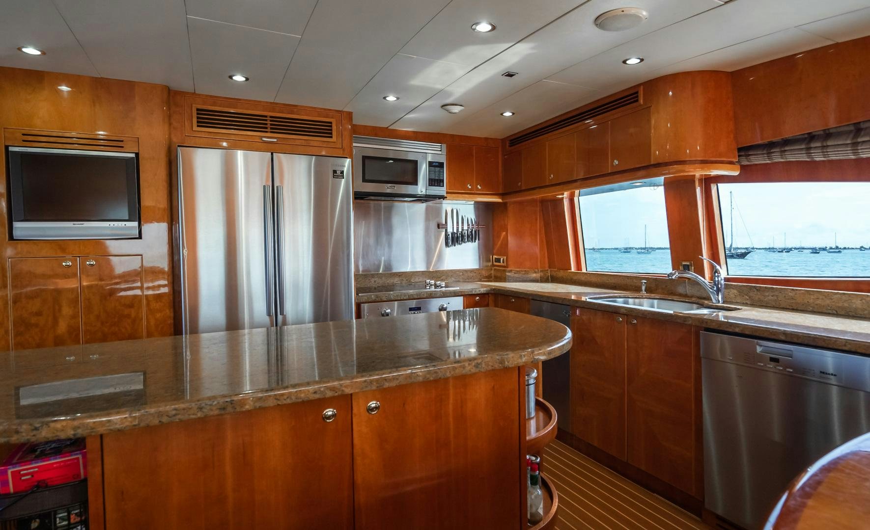 a kitchen with wooden cabinets aboard VITESSE Yacht for Sale